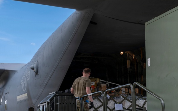 346th Air Expeditionary Wing unloads cargo off a C-130J