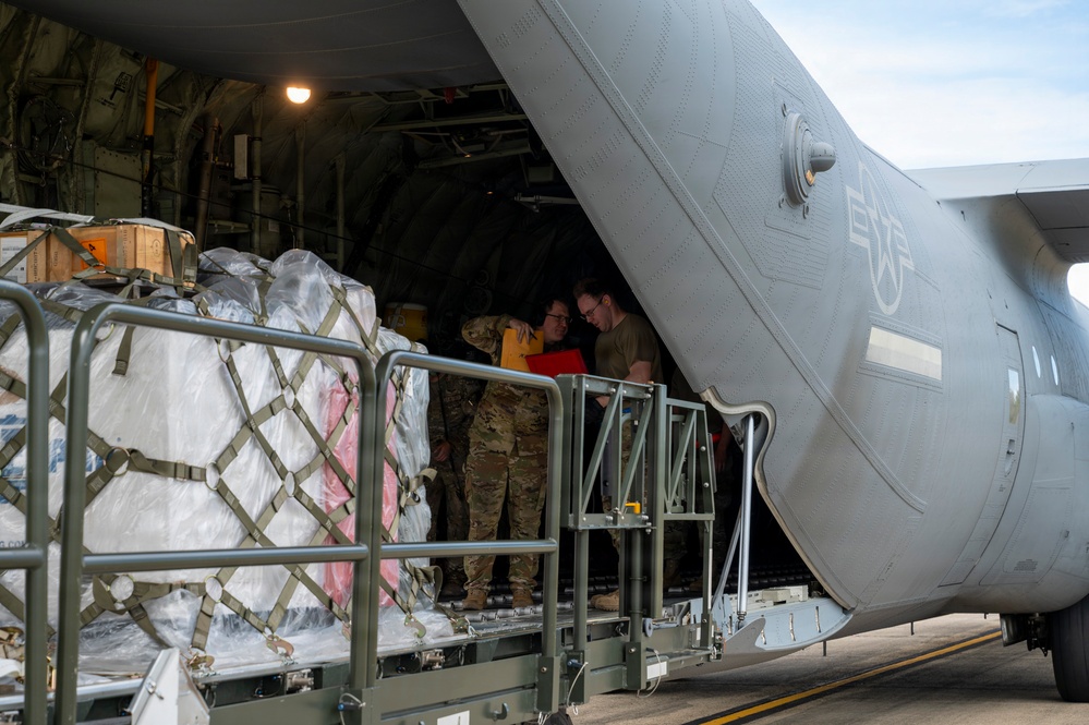 346th Air Expeditionary Wing unloads cargo off a C-130J