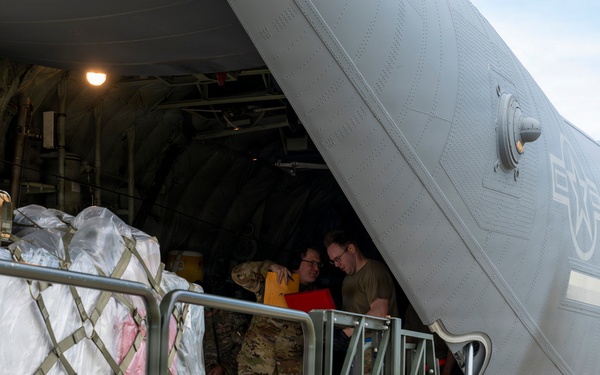 346th Air Expeditionary Wing unloads cargo off a C-130J