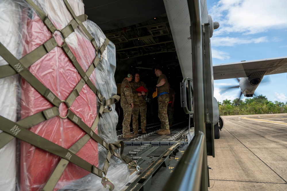 346th Air Expeditionary Wing unloads cargo off a C-130J
