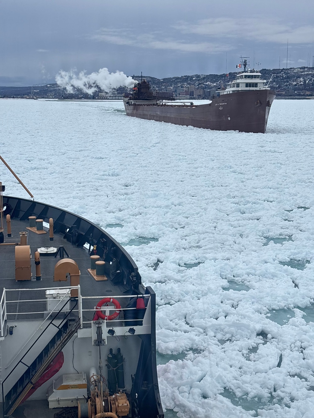 Coast Guard Cutter SPAR (WLB 206) assists motor vessel Lee A. Tregurtha, beset by ice on Lake Superior