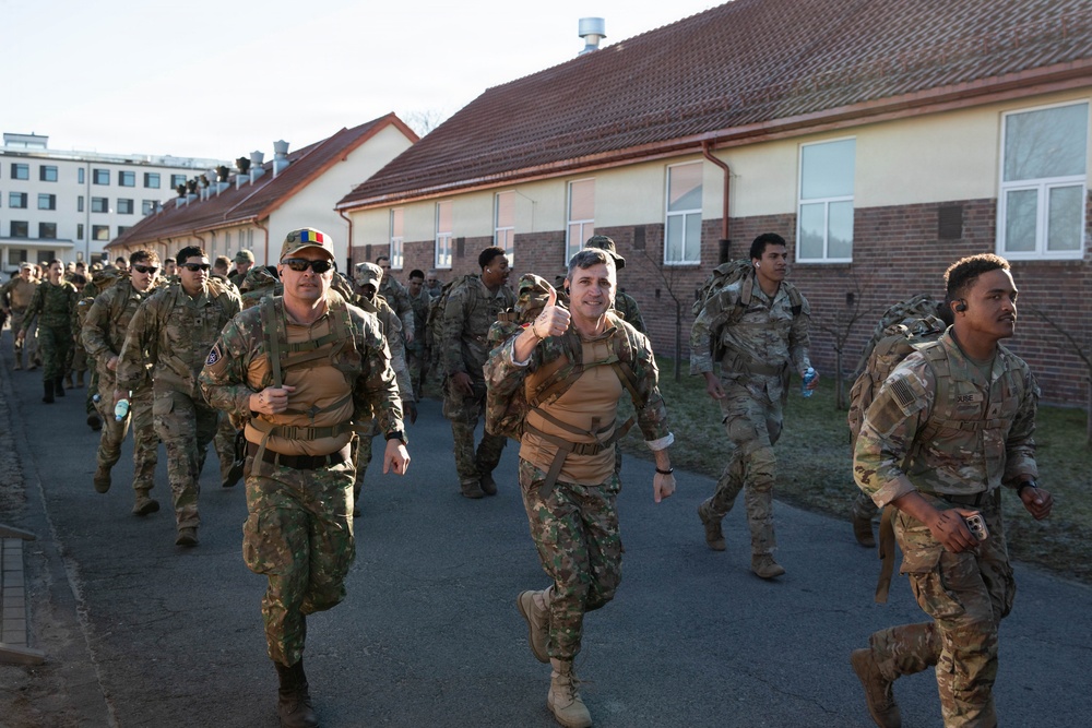 U.S. Soldiers and NATO Forward Land Forces Battle Group-Poland ruck march side-by-side