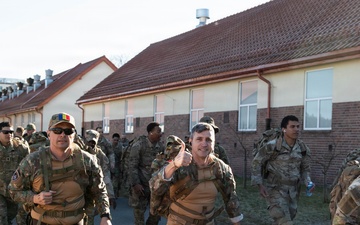U.S. Soldiers and NATO Forward Land Forces Battle Group-Poland ruck march side-by-side