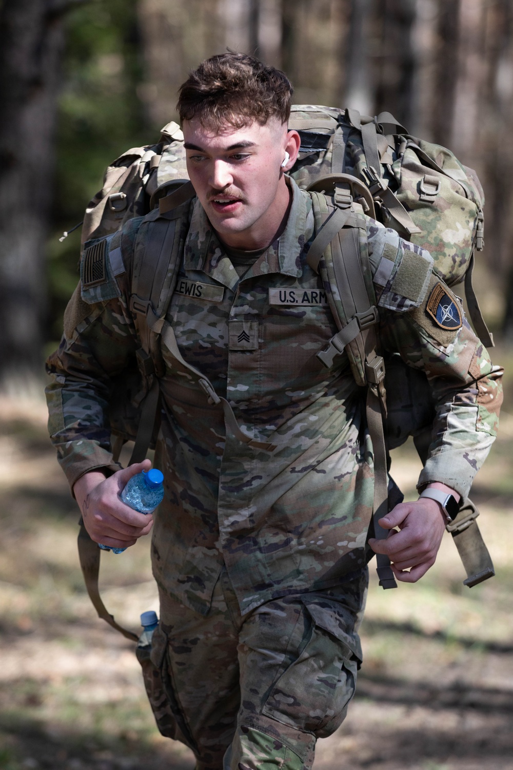 U.S. Soldiers and NATO Forward Land Forces Battle Group-Poland ruck march side-by-side