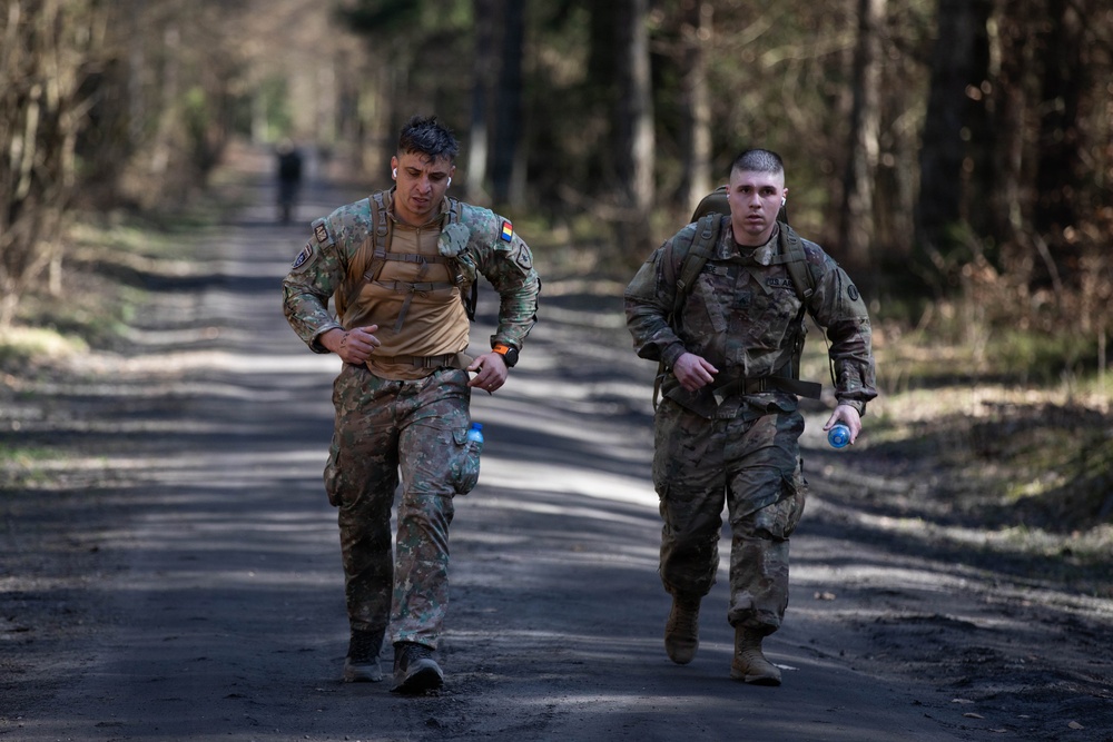 U.S. Soldiers and NATO Forward Land Forces Battle Group-Poland ruck march side-by-side