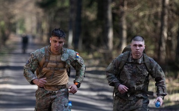 U.S. Soldiers and NATO Forward Land Forces Battle Group-Poland ruck march side-by-side