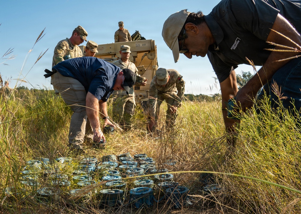 Personnel inspect and organize deployed M139 inert munitions (M88R)
