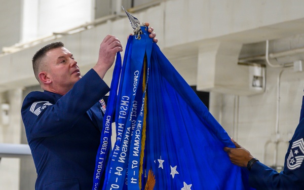 Command chief adds streamer during change of responsibility ceremony