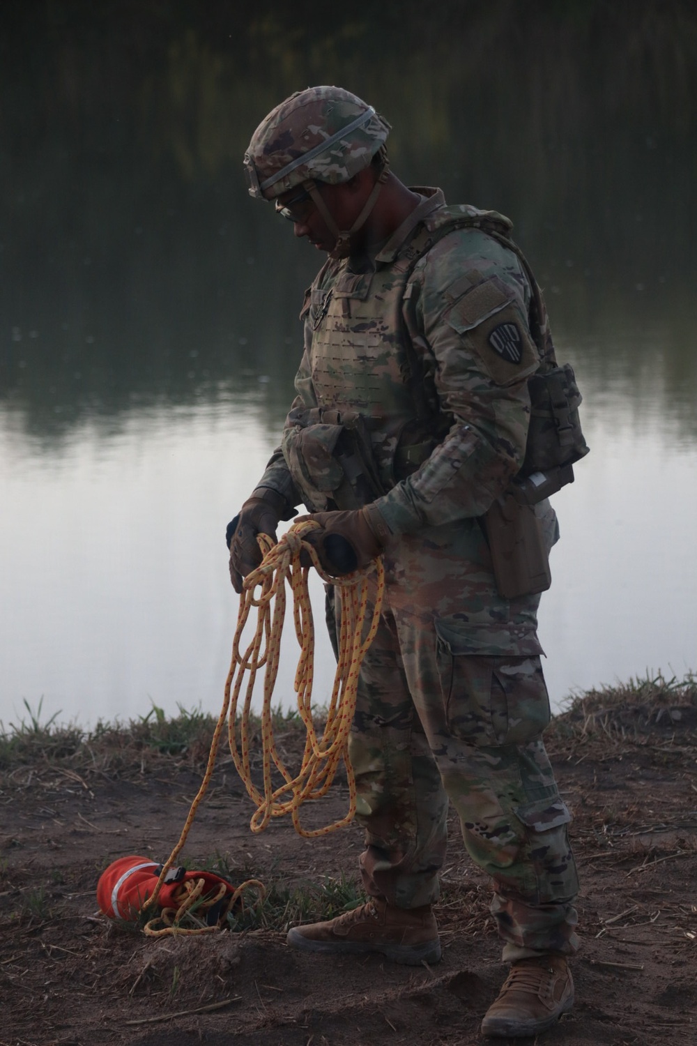U.S. Army Spc. Jahdaniel Garcia assigned to JTF-SB, organizes ropes after aiding in the rescue of three illegal aliens attempting to cross the U.S. Southern Border.