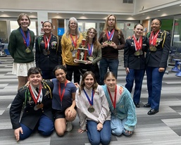 Fort Knox High School academic decathlon team members pose with their medals and trophy