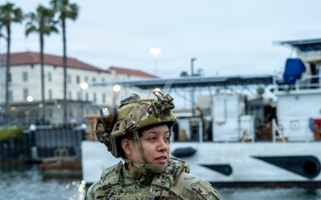 Coast Guard members conduct large vessel security boarding