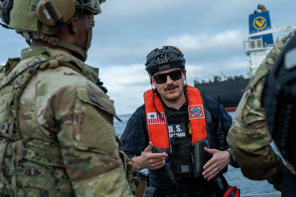 Coast Guard members conduct large vessel security boarding