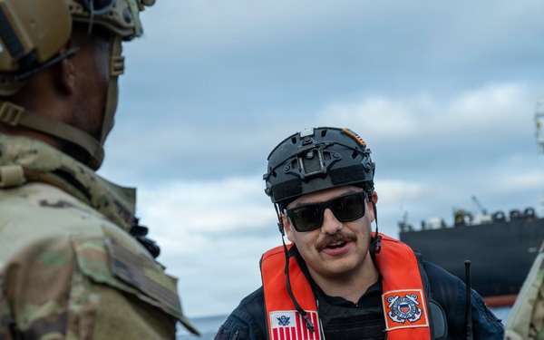 Coast Guard members conduct large vessel security boarding