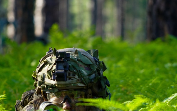 "Screaming Eagle" Soldier observes security with M249 SAW at JRTC