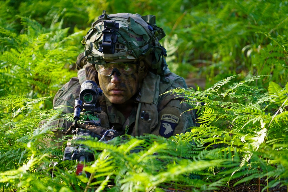 MFRC Soldier observes security with M249 SAW at JRTC