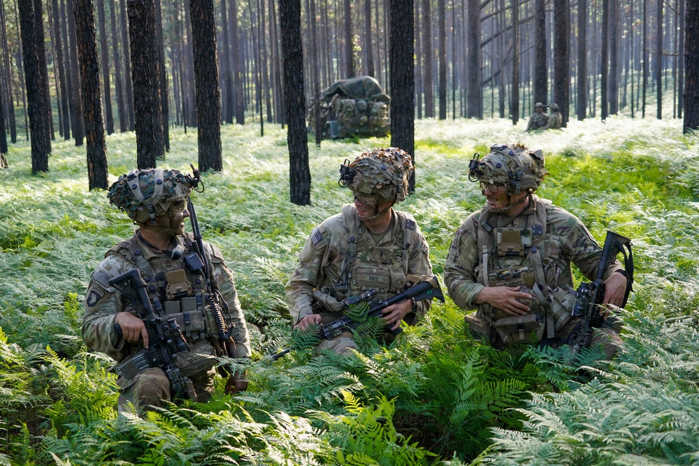 MFRC Soldiers discuss tactics and movement while training at JRTC