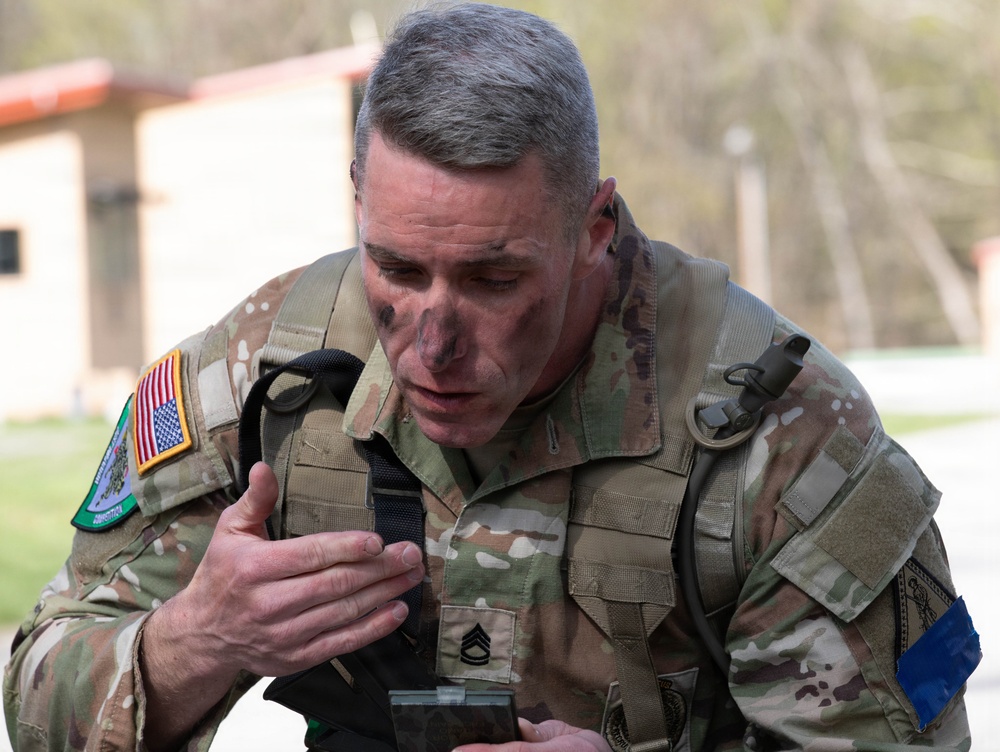 Soldier applies camouflage paint