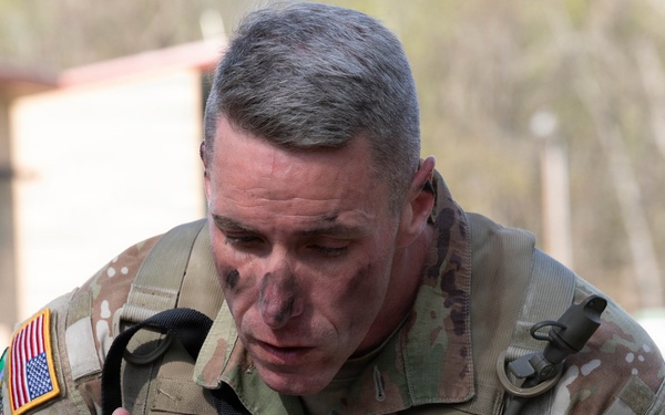 Soldier applies camouflage paint