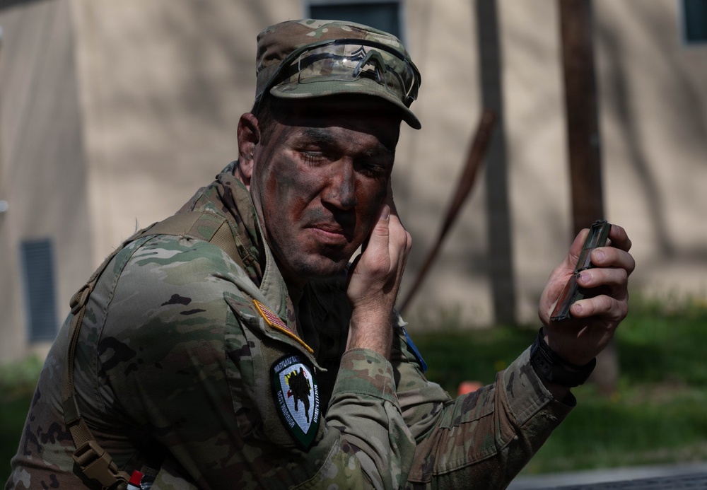 Soldier applies camouflage paint