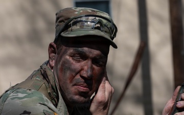 Soldier applies camouflage paint