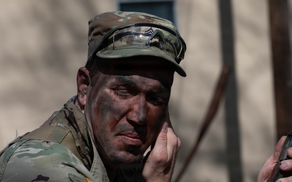 Soldier applies camouflage paint