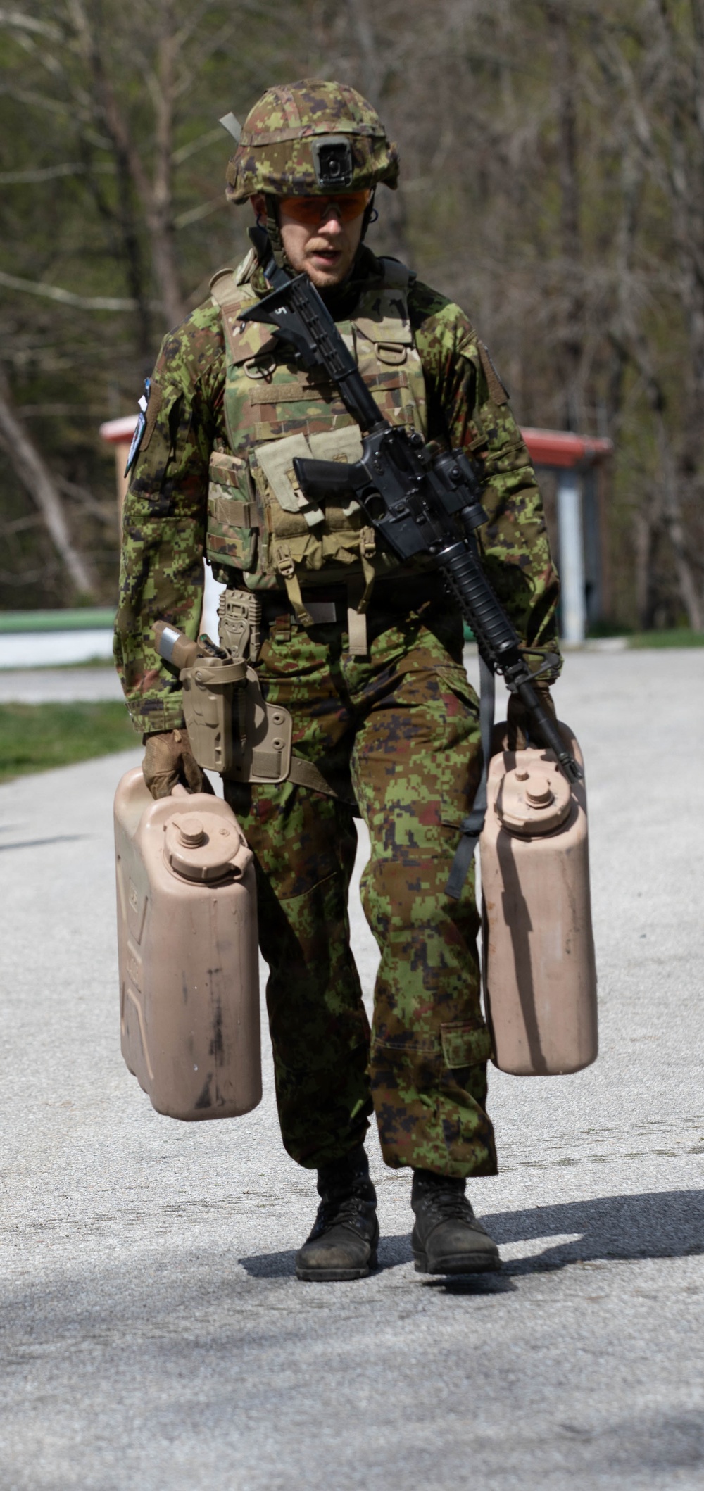 Competitor carries water cans