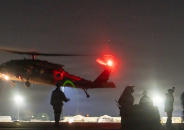 Soldiers rig cargo net loads for UH-60 Black Hawk resupply during nighttime JRTC operations