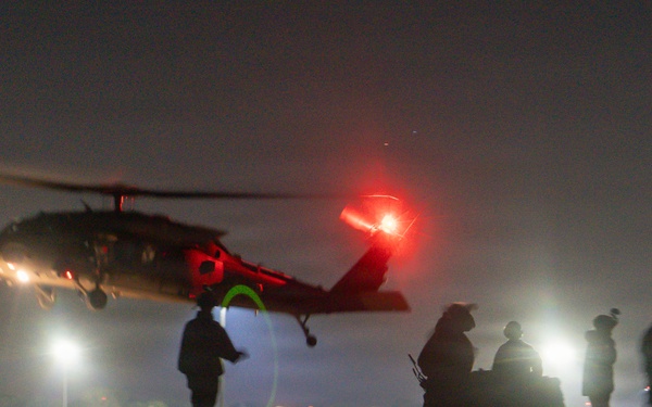 Soldiers rig cargo net loads for UH-60 Black Hawk resupply during nighttime JRTC operations