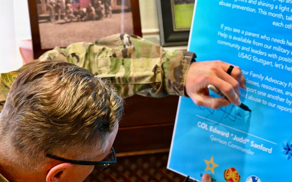 Col. Edward Sanford and Command Sgt. Maj. Chris Melendez sign the Child Abuse Prevention Month Proclamation