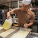 U.S. Sailors prepare food in the galley of USS John Finn