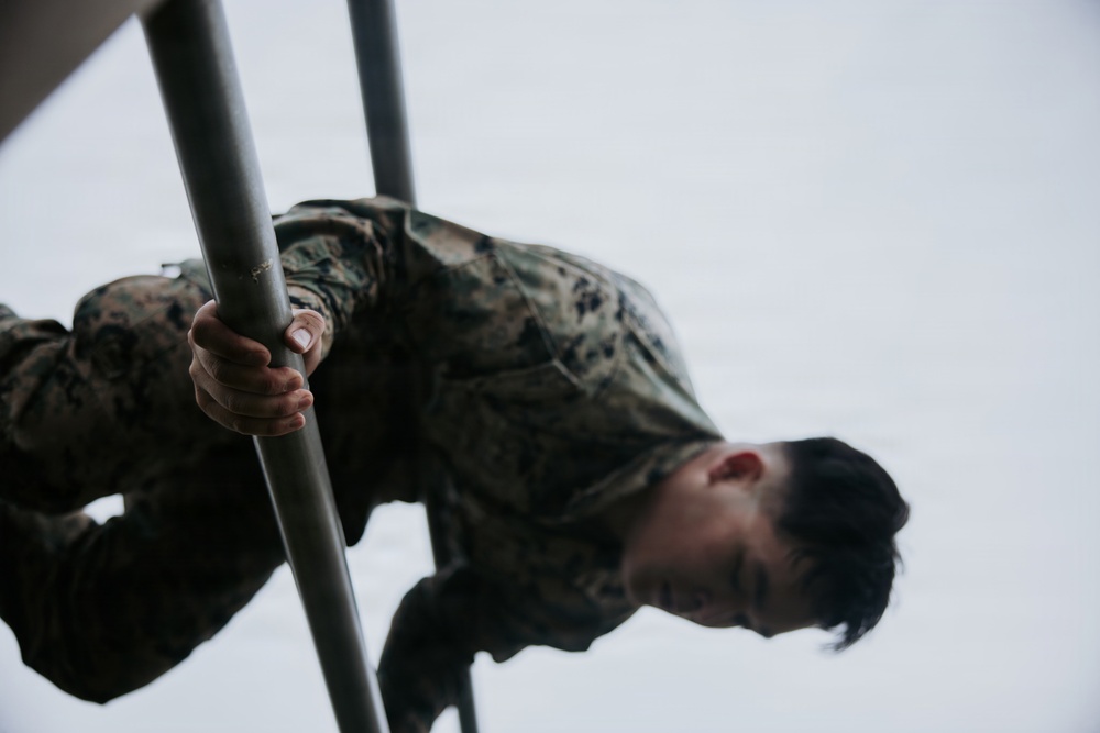 U.S. Marines tackle obstacle course during communication strategy and operations field training exercise