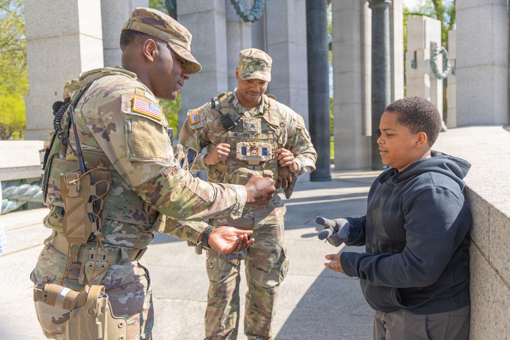 Mississippi National Guard Soldiers plays rock paper scissors at the WWII Memorial