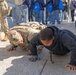 Mississippi National Guard Soldier engages in push-ups with a member of the public
