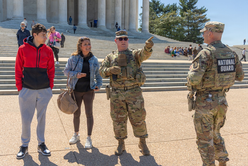 Mississippi National Guard Soldier helps a member of the public with directions