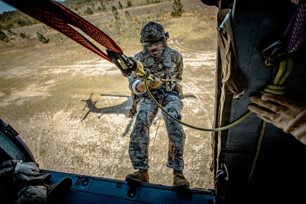 7th SFG (A) soldier rappels from a UH-60