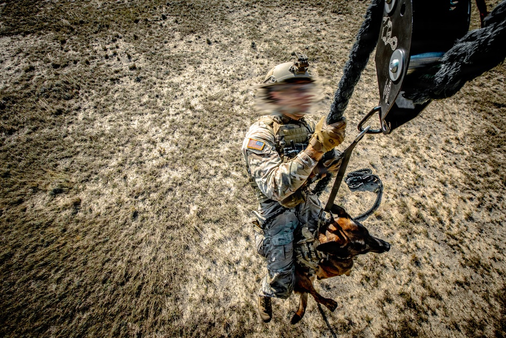 7th SFG (A) soldier rappels with K9 from a UH-60 flown