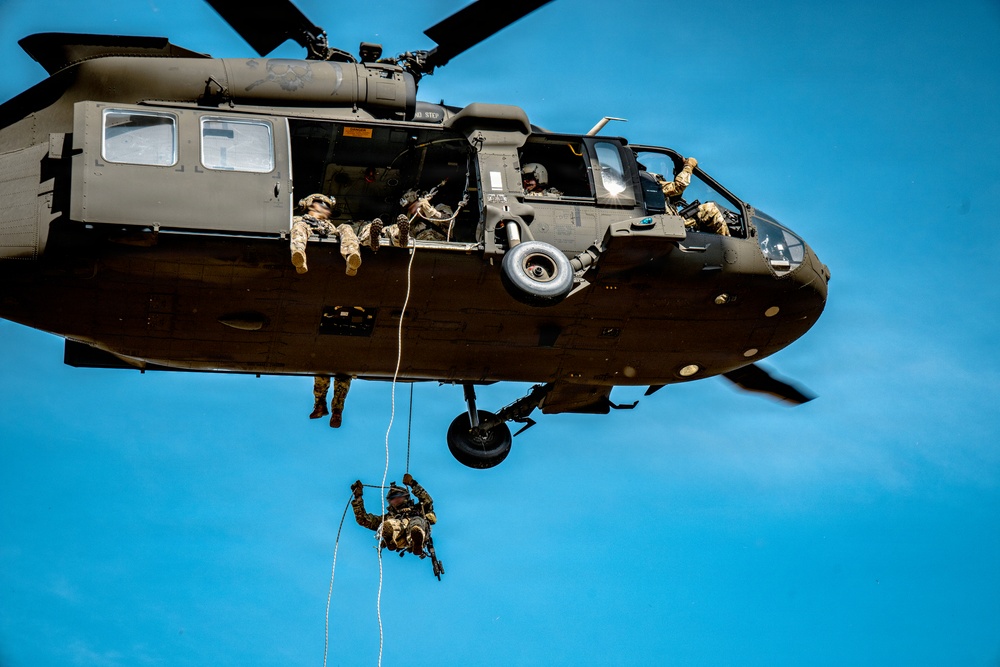 7th SFG (A) soldier rappels from a UH-60