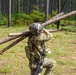 101st Soldier cuts wood to improve fighting position at JRTC