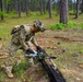 101st Soldier cuts wood to improve fighting position at JRTC