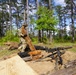 101st Soldier cuts wood to improve fighting position at JRTC