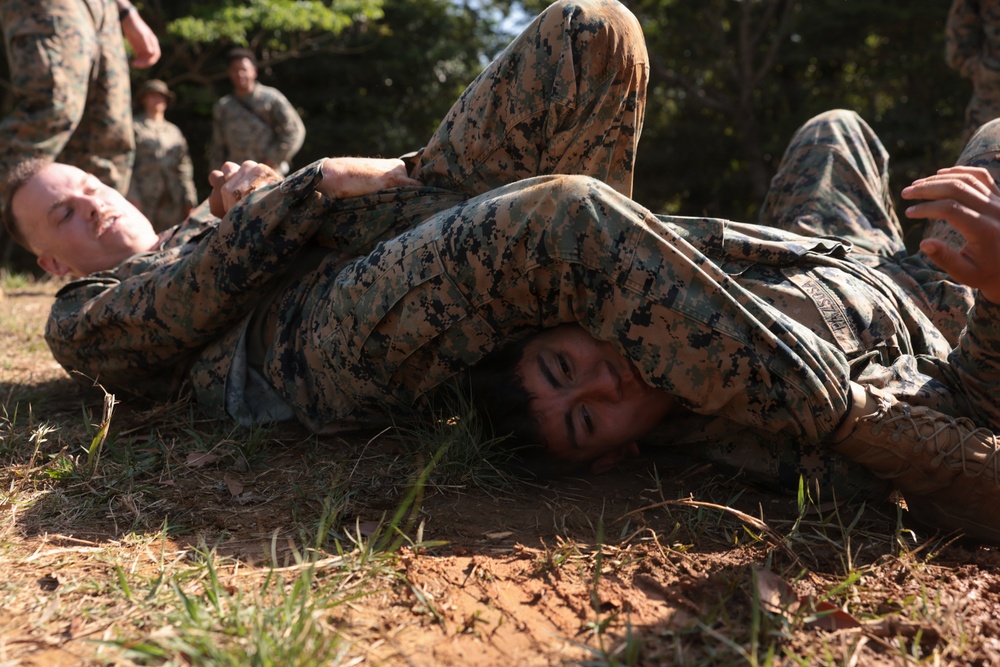 U.S. Marines conduct 12-kilometer hike and Marine Corps Martial Arts Program training during Communication Strategy and Operations Field Training Exercise