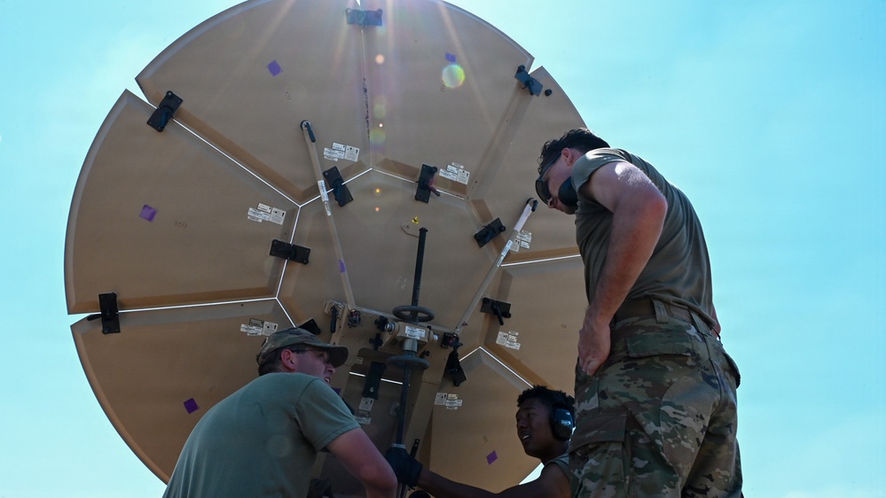 U.S. Air Force 644th Combat Communication Squadron Airmen installs a satellite communication dish