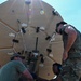 U.S. Air Force 644th Combat Communication Squadron Airmen installs a satellite communication dish