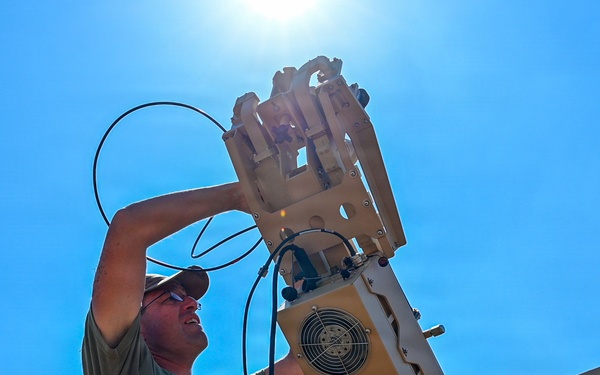 U.S. Air Force 644th Combat Communication Squadron Airmen installs a satellite communication dish