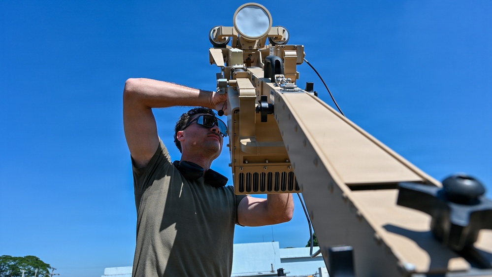 U.S. Air Force 644th Combat Communication Squadron Airmen installs a satellite communication dish