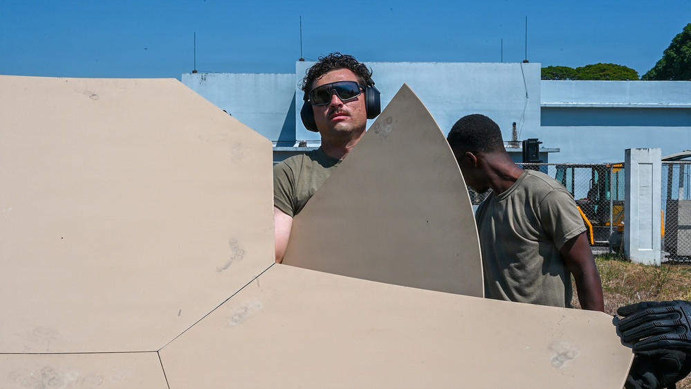 U.S. Air Force 644th Combat Communication Squadron Airmen installs a satellite communication dish