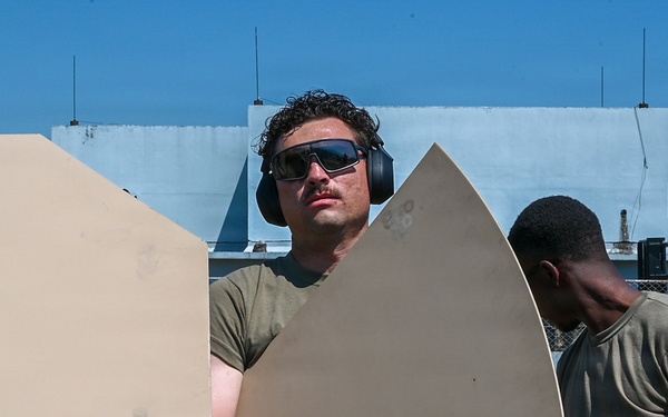 U.S. Air Force 644th Combat Communication Squadron Airmen installs a satellite communication dish