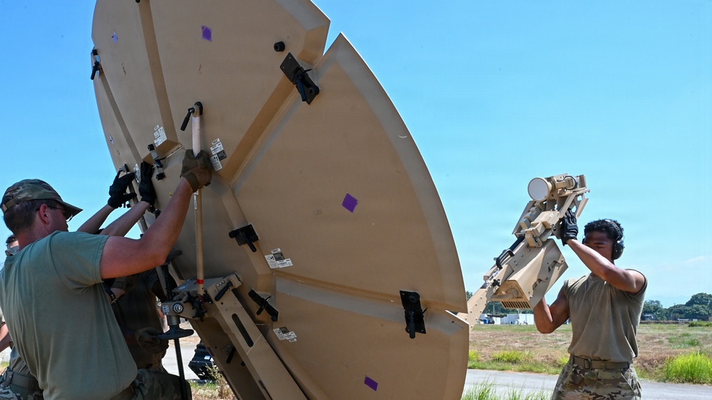 U.S. Air Force 644th Combat Communication Squadron Airmen installs a satellite communication dish