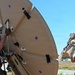 U.S. Air Force 644th Combat Communication Squadron Airmen installs a satellite communication dish