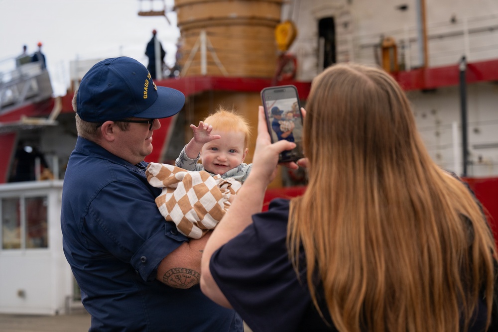 A U.S. Coast Guard Cutter Polar Star (WAGB 10) crew member poses for a family photo at Coast Guard Base Seattle after being reunited with family following a 146-day Antarctic deployment in support of Operation Deep Freeze, April 13, 2026.
